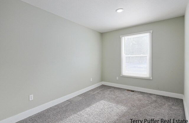 unfurnished room featuring carpet