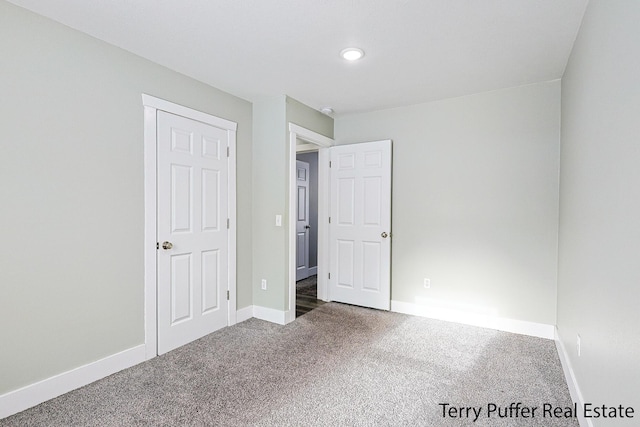 unfurnished bedroom featuring dark carpet