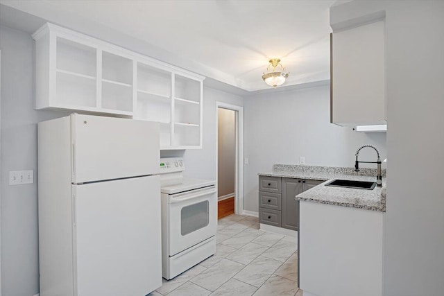 kitchen with gray cabinetry, sink, light stone counters, white appliances, and white cabinets