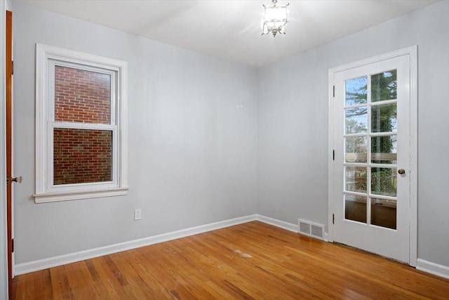 unfurnished room with hardwood / wood-style flooring