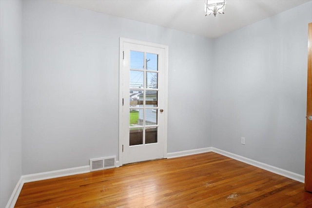 empty room with hardwood / wood-style flooring