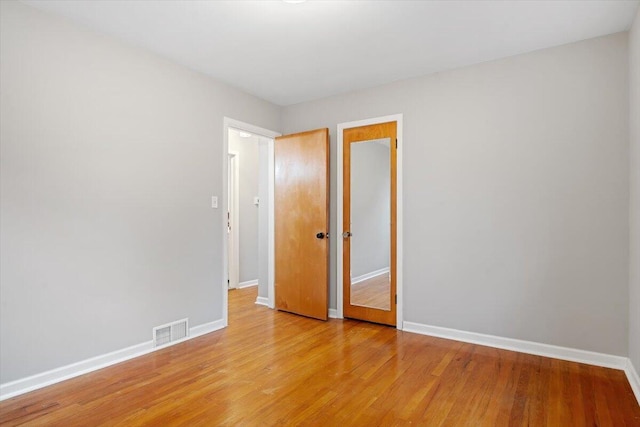 empty room with light hardwood / wood-style floors