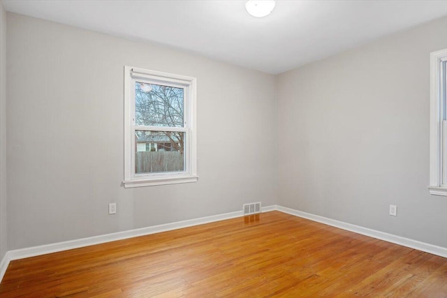 spare room featuring wood-type flooring