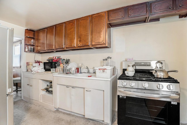 kitchen featuring appliances with stainless steel finishes and light colored carpet