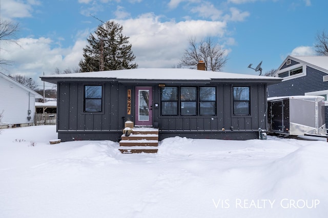 view of front of property with board and batten siding and a chimney