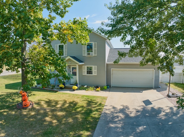 view of front of house with a front yard and a garage