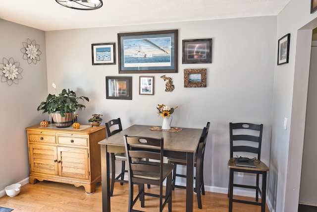 dining space with hardwood / wood-style floors