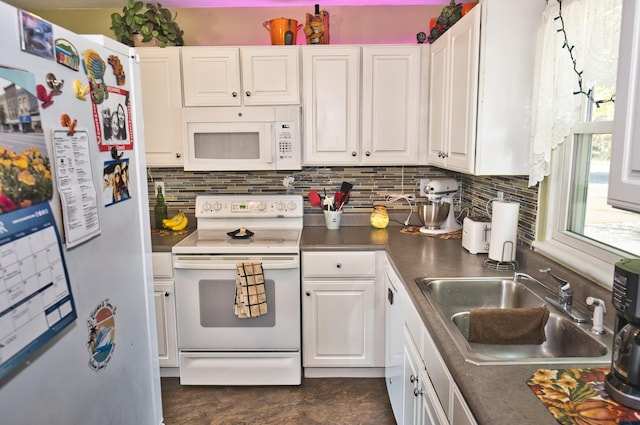 kitchen with white appliances, tasteful backsplash, white cabinetry, and sink