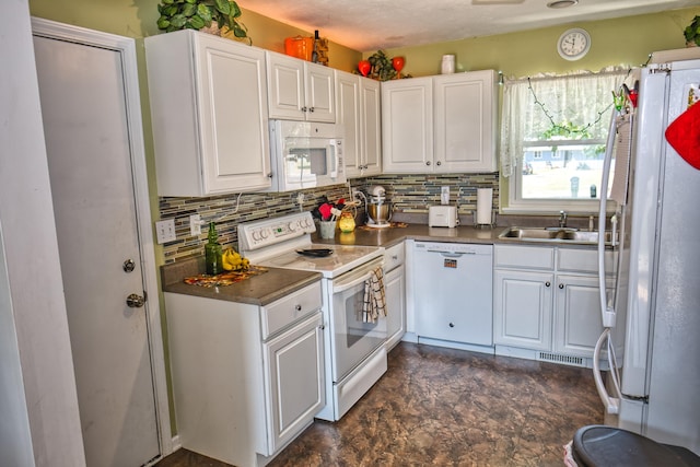 kitchen featuring white cabinets, white appliances, tasteful backsplash, and sink