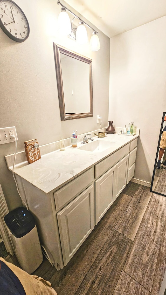 bathroom with hardwood / wood-style floors and vanity