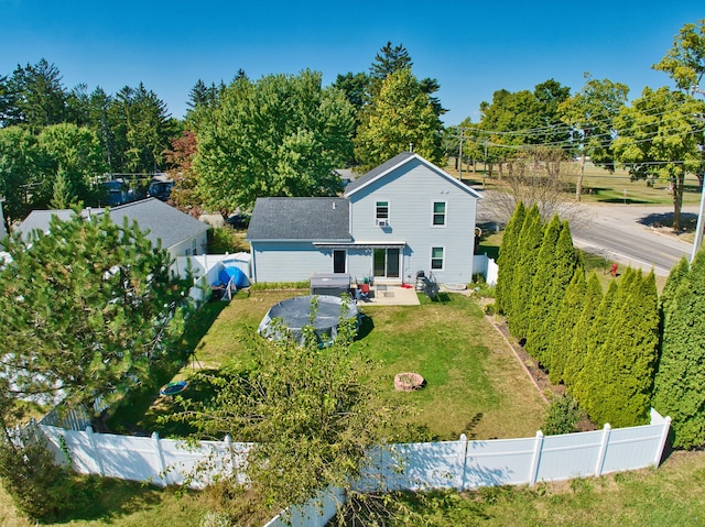 rear view of property with a yard and a patio