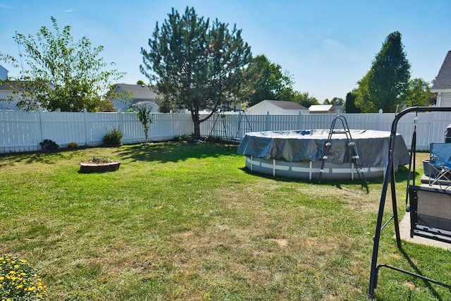 view of yard with a covered pool