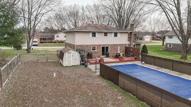 view of pool with a shed, cooling unit, and a deck