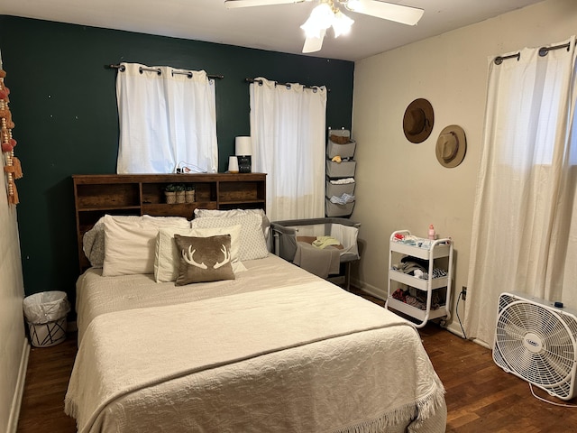 bedroom with dark hardwood / wood-style floors and ceiling fan