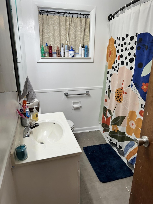 bathroom featuring vanity, toilet, and walk in shower