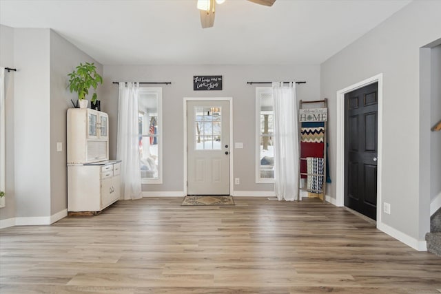 foyer entrance featuring light hardwood / wood-style floors and ceiling fan