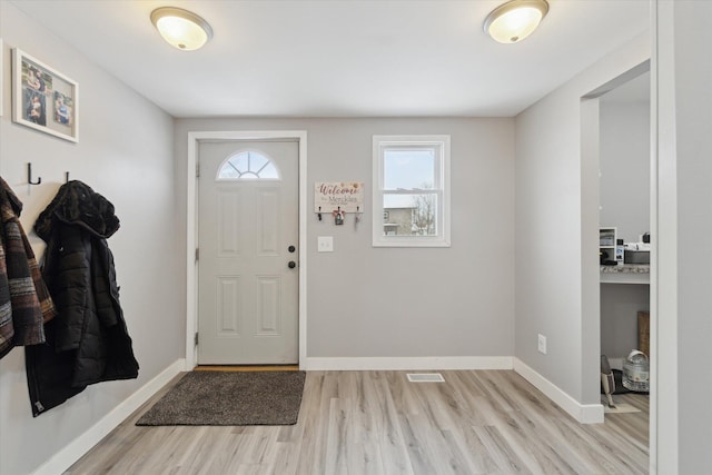 foyer featuring plenty of natural light and light hardwood / wood-style flooring