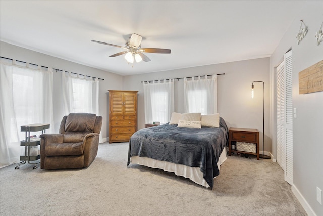 bedroom with light carpet, a closet, and ceiling fan