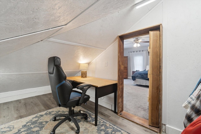 office space with ceiling fan, vaulted ceiling, and hardwood / wood-style flooring