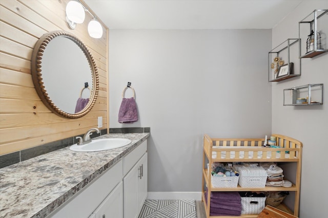 bathroom with vanity, tile patterned floors, and wood walls