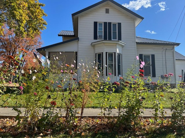 back of property featuring a sunroom