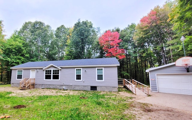 view of front facade with an outbuilding and a garage