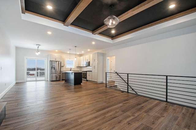 living room with a raised ceiling and dark wood-type flooring