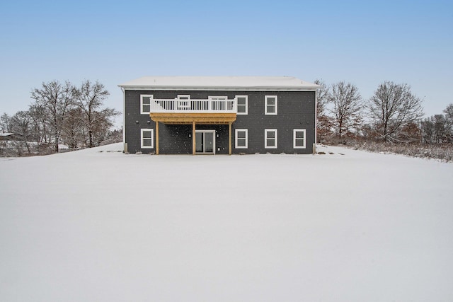 snow covered house with a deck