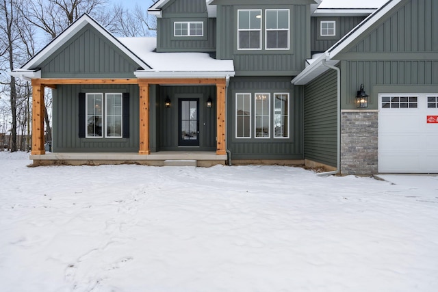 view of front of property with covered porch and a garage