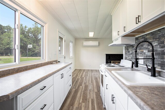 kitchen with tasteful backsplash, white range with electric stovetop, wood-type flooring, extractor fan, and white cabinets