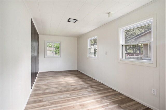 unfurnished room with light hardwood / wood-style floors