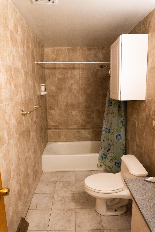 full bathroom featuring tile patterned floors, vanity, shower / tub combo with curtain, tile walls, and toilet