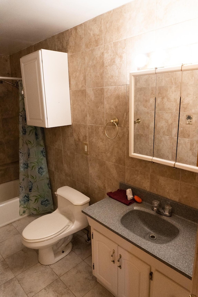 full bathroom featuring tile patterned flooring, toilet, shower / tub combo with curtain, vanity, and tile walls