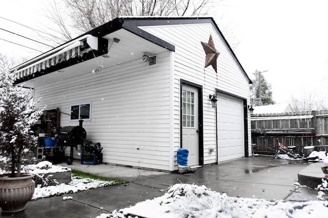 snow covered property featuring a garage