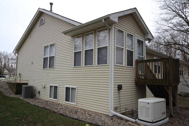 view of side of property with central air condition unit