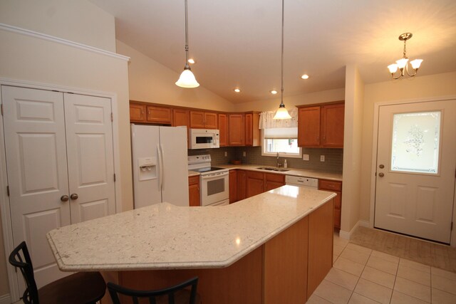 kitchen with lofted ceiling, a center island, white appliances, and sink