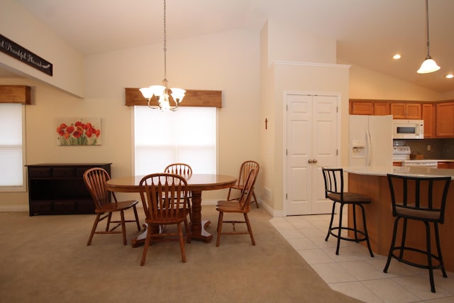 tiled dining area featuring a chandelier, high vaulted ceiling, and a healthy amount of sunlight