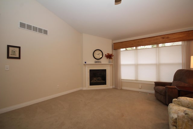 unfurnished living room with light carpet and vaulted ceiling