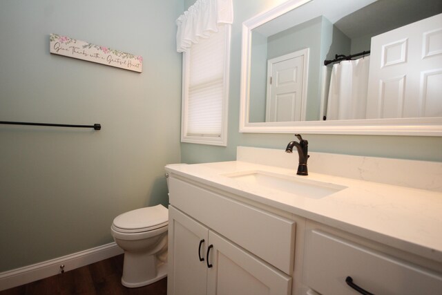 bathroom featuring hardwood / wood-style flooring, vanity, and toilet