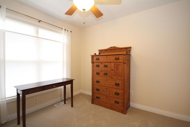 interior space with light carpet and ceiling fan