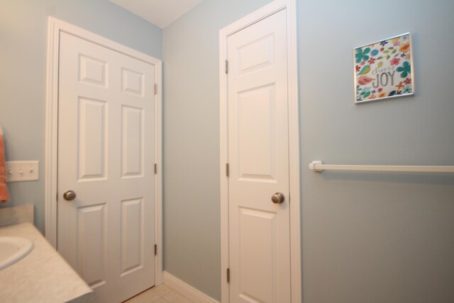 bathroom with tile patterned flooring and vanity