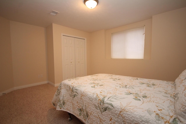 carpeted bedroom with a closet