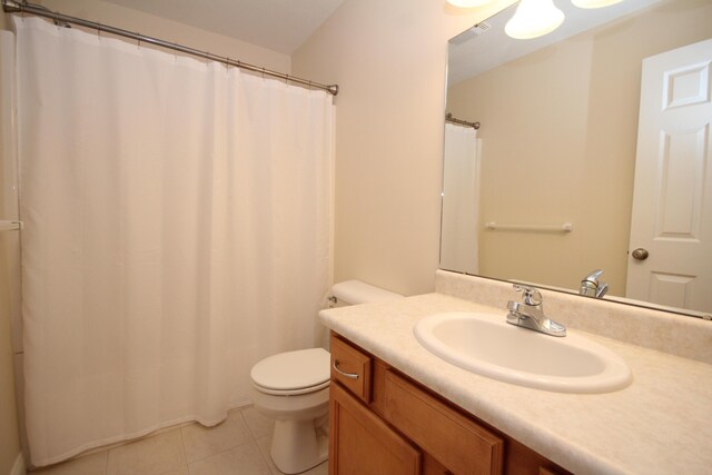 bathroom featuring toilet, vanity, and tile patterned floors