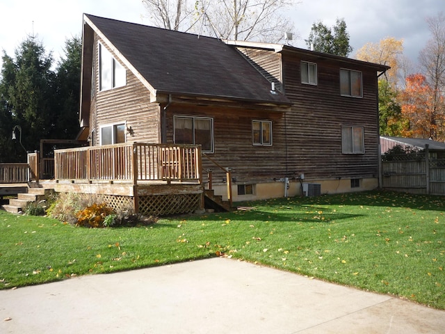 back of property featuring a yard, a deck, and central AC unit