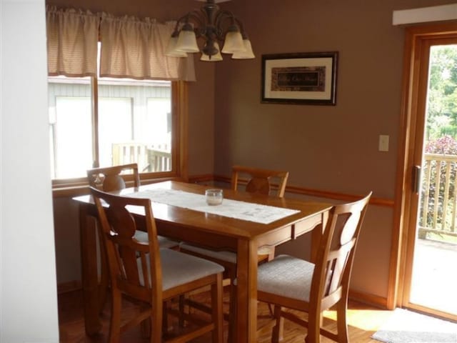 dining room featuring wood-type flooring and a chandelier