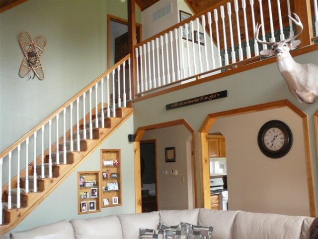 living room with high vaulted ceiling