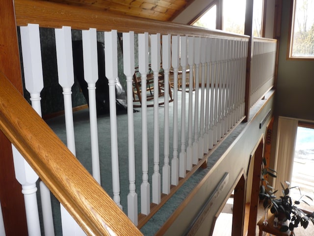 staircase featuring a healthy amount of sunlight and lofted ceiling