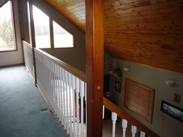 hall with light carpet, vaulted ceiling, and wooden ceiling