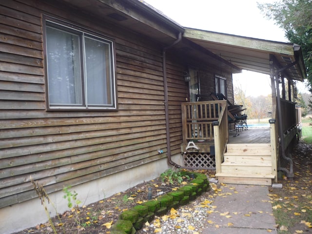 view of side of property featuring a wooden deck