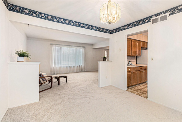 interior space with light carpet and an inviting chandelier